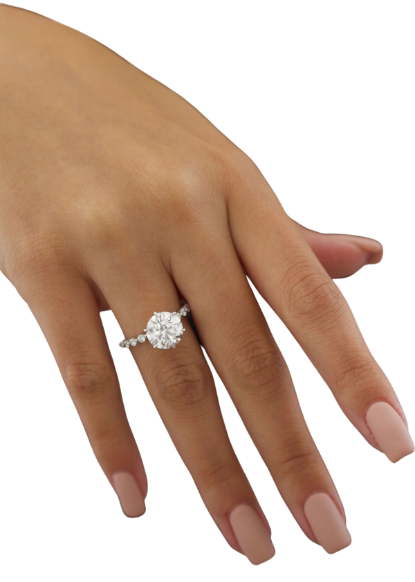 A solitaire diamond ring photographed on a hand, from the studio&rsquo;s own pictures